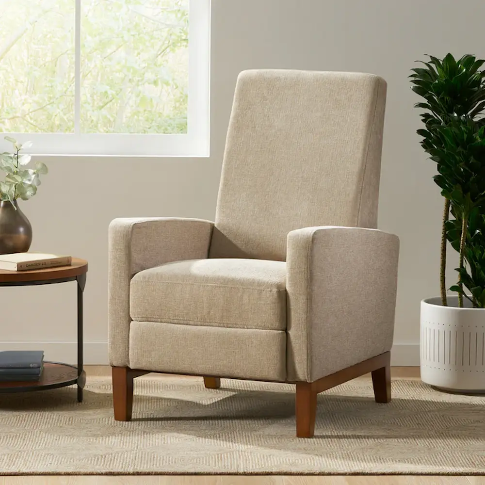 Beige upholstered wingback chair in living room setting.