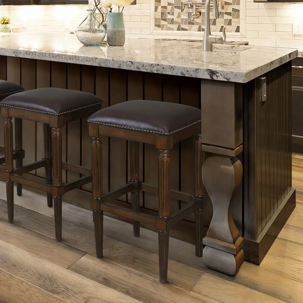 Elegant kitchen island with stools and marble countertop.