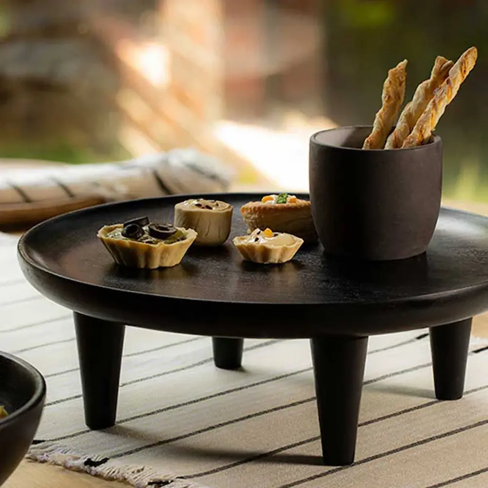 Gourmet appetizers on elegant black serving tray.