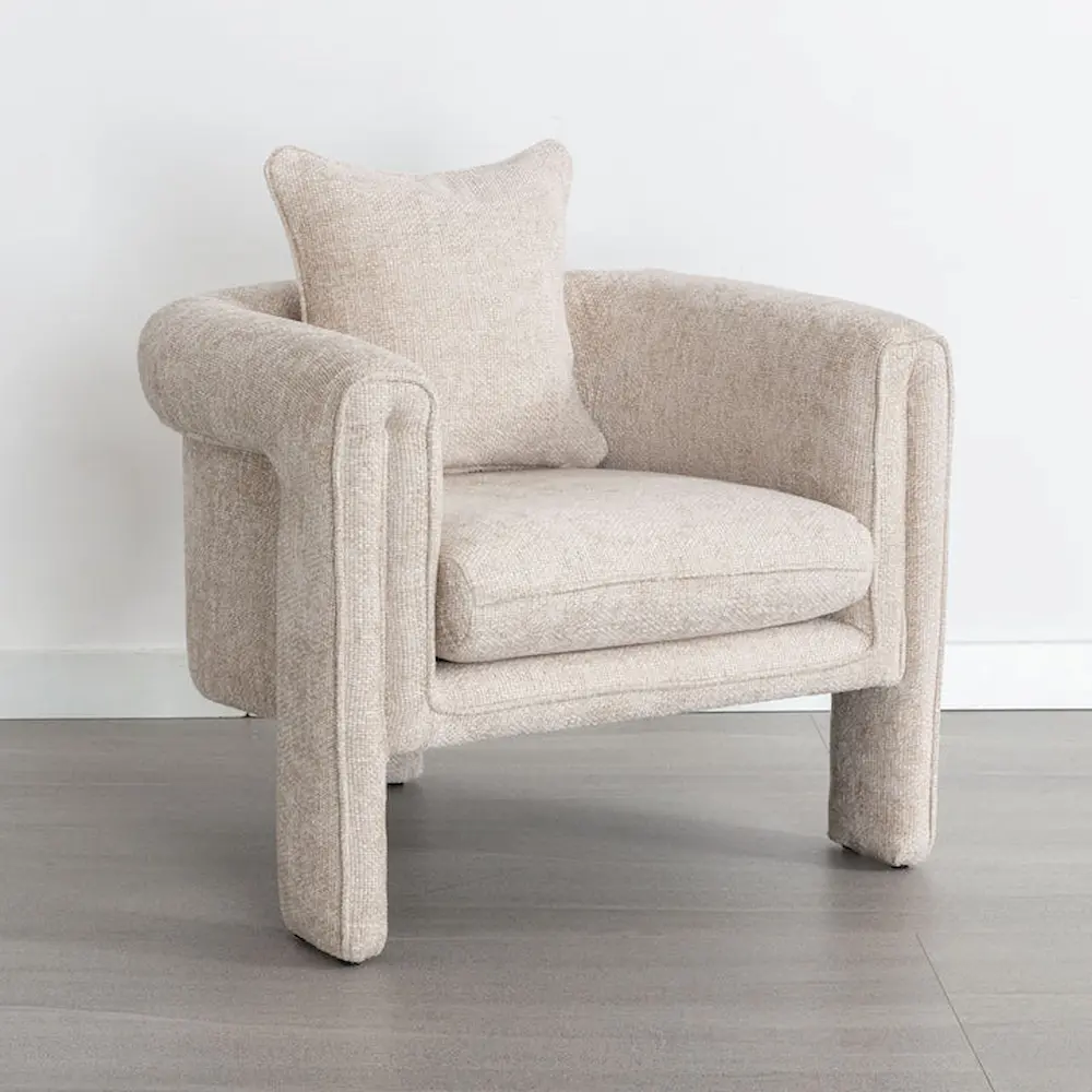 Beige fabric armchair on gray flooring.