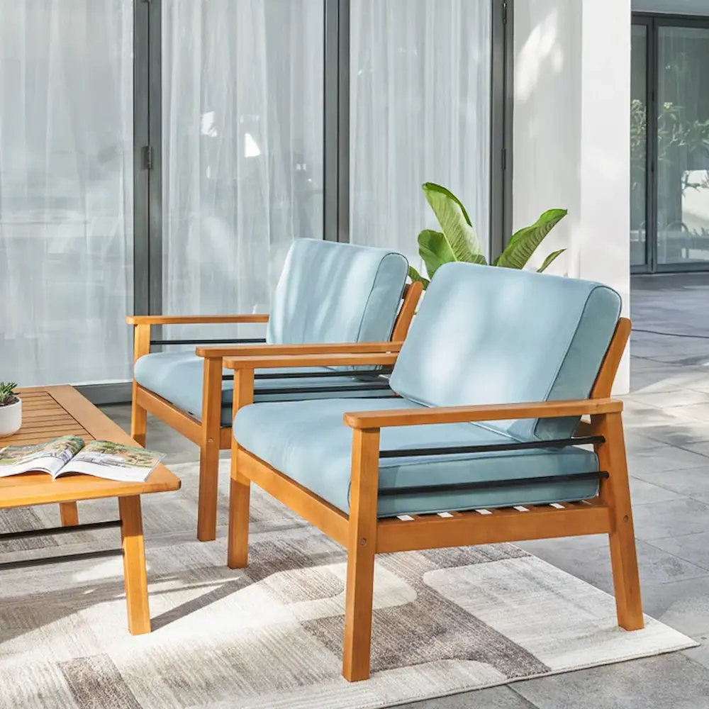 Modern outdoor patio chairs with blue cushions.