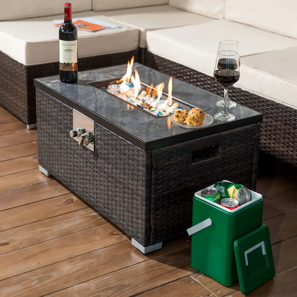 Outdoor fire pit table with wine and snacks.