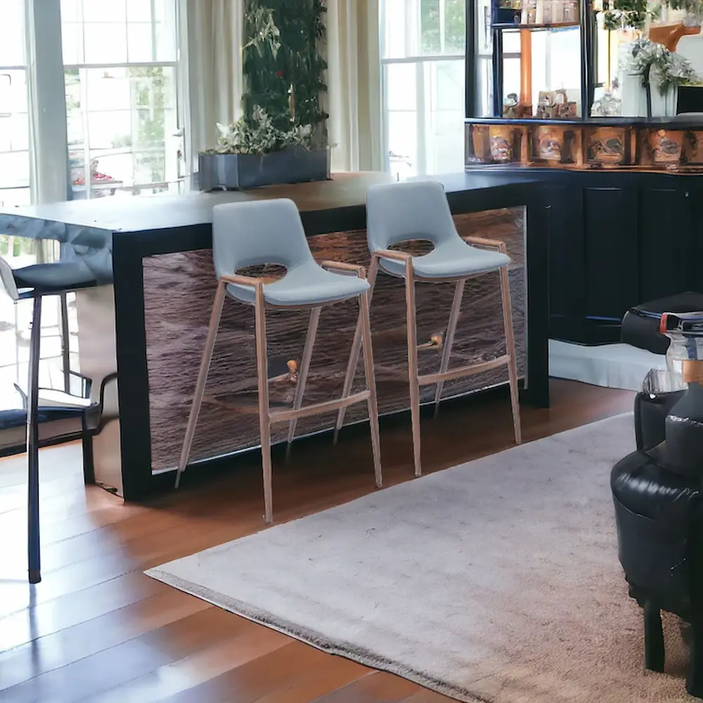 Modern kitchen with bar stools and hardwood floors.