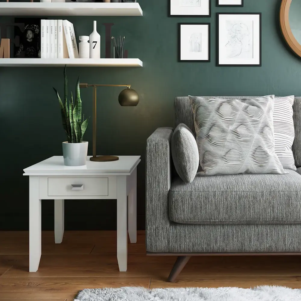 Modern living room with grey sofa and green wall.