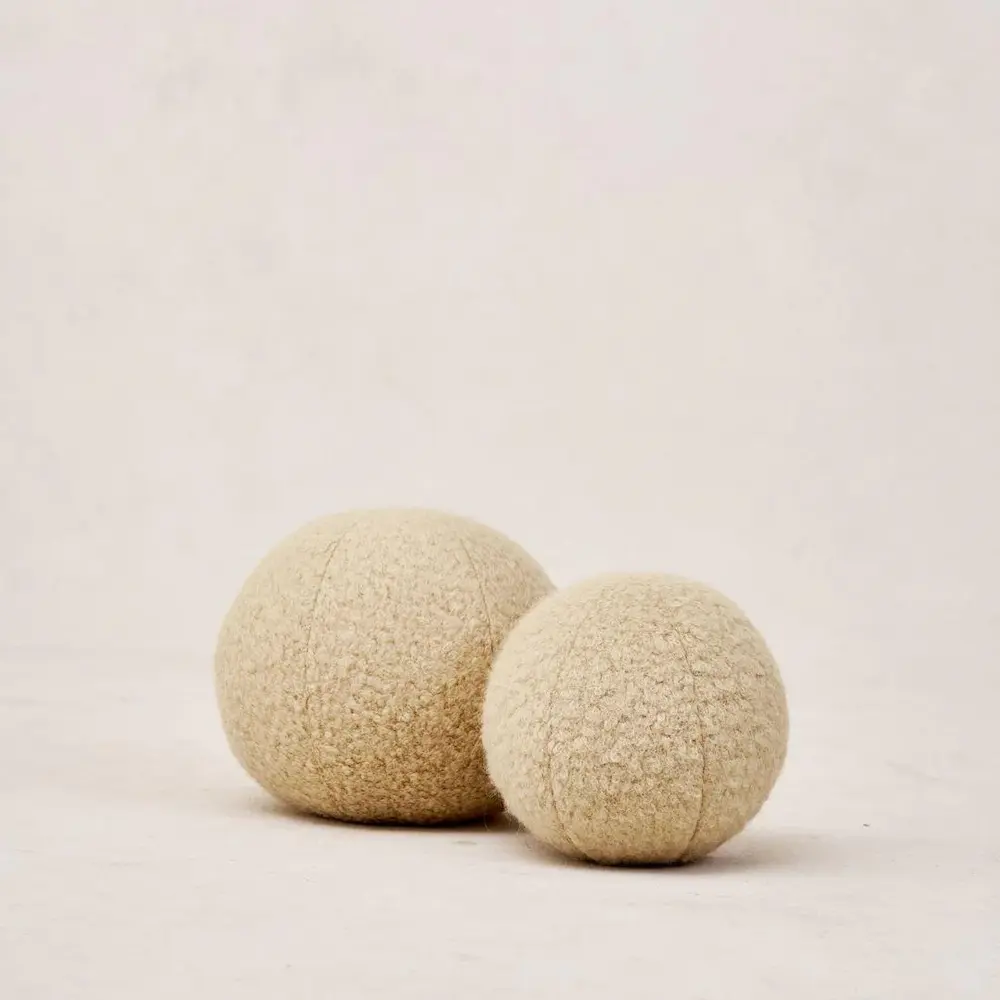 Two textured tan spheres on a plain background.