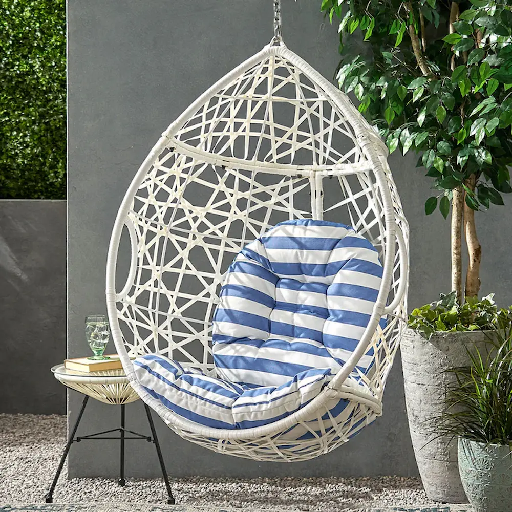 White hanging egg chair with blue striped cushion.